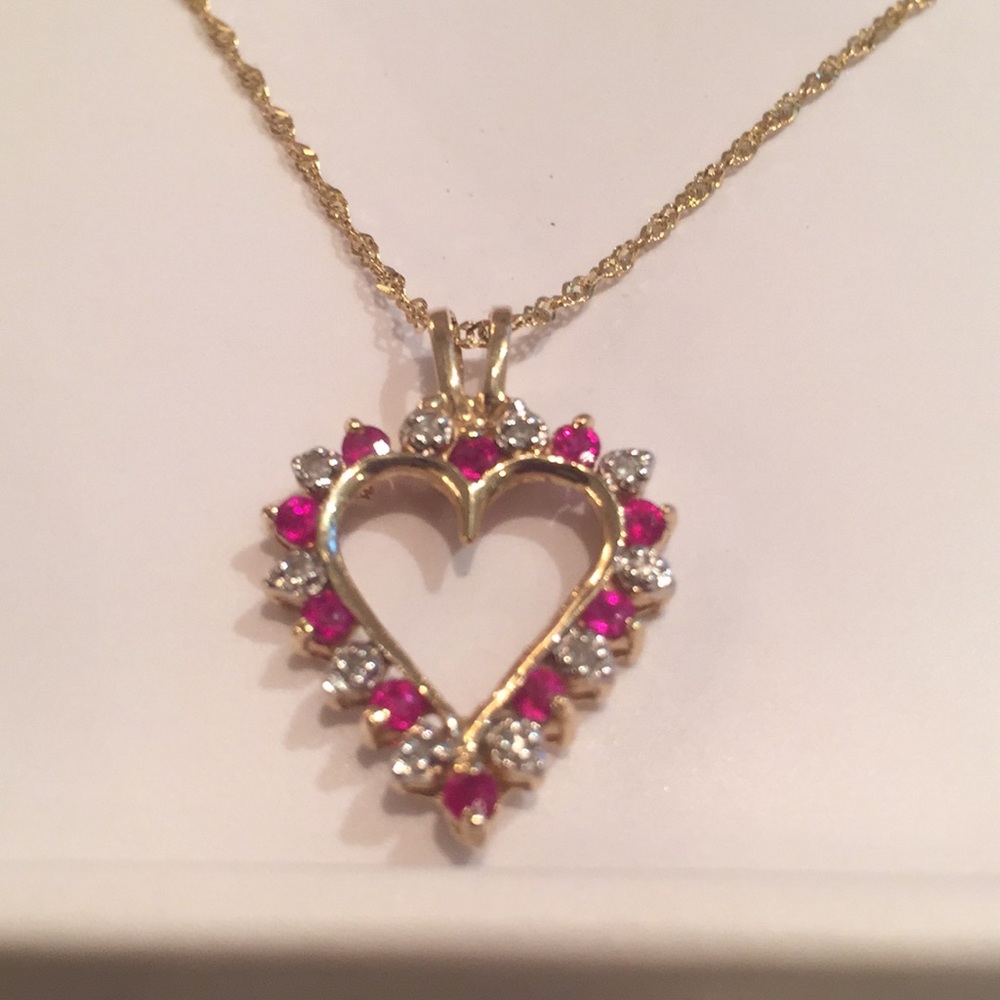 Gold heart necklace with small diamonds and rubies